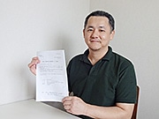 八重山そば選手権への参加をPRする実行委員会広報の金銅さん