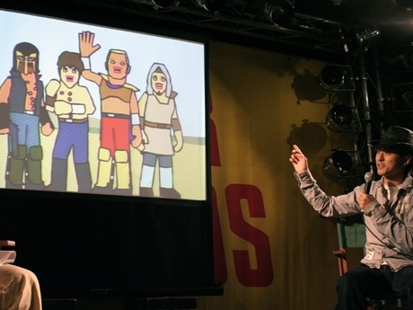 イベントで作品について話す文原聡さん。代表作「ザ・ワールド・オブ・ゴールデン・エッグス」風のキャラを披露した