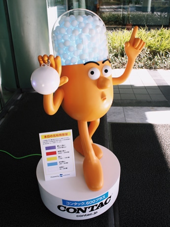 千駄ヶ谷・GSK本社ビル前に登場した「ミスターコンタック」ロボ。光る頭で花粉量（写真＝青色はやや少なめ）を知らせる