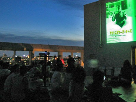 寝そべったり酒を飲んだり、自由なスタイルで映画を楽しむ来場者（7月28日）