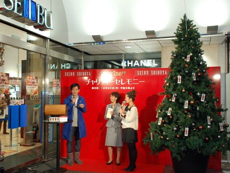 西武渋谷店のクリスマス企画の一環でキャンドルを飾ったツリーが登場。左からセレモニーに参加した山田遊さん、渡辺由美子さん、司会の雨宮朋絵さん