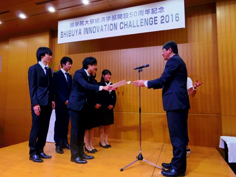 最優秀賞に輝いたグループ通話（3年）のメンバーと尾近裕幸経済学部長