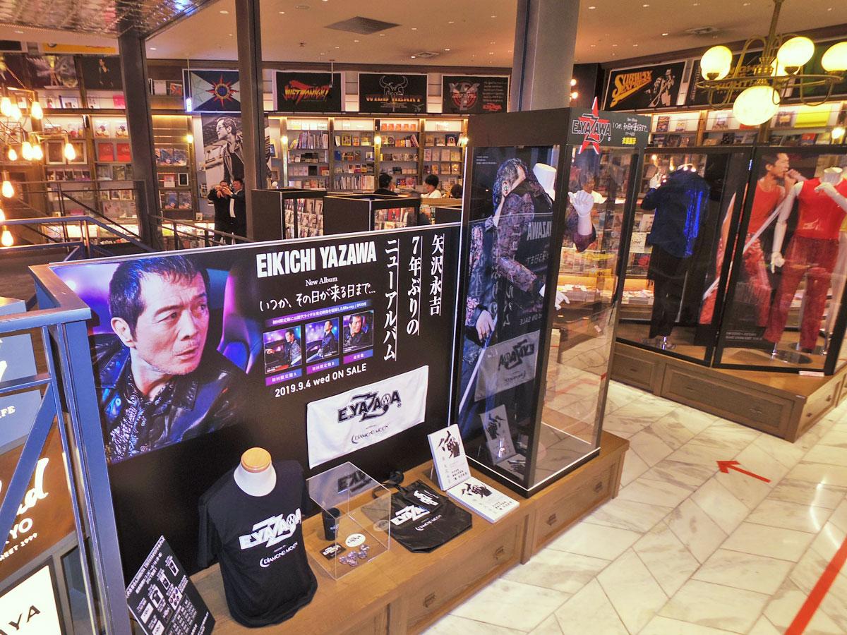 ステージ衣装やライブグッズのビーチタオルなどを展示するコラボカフェ店内