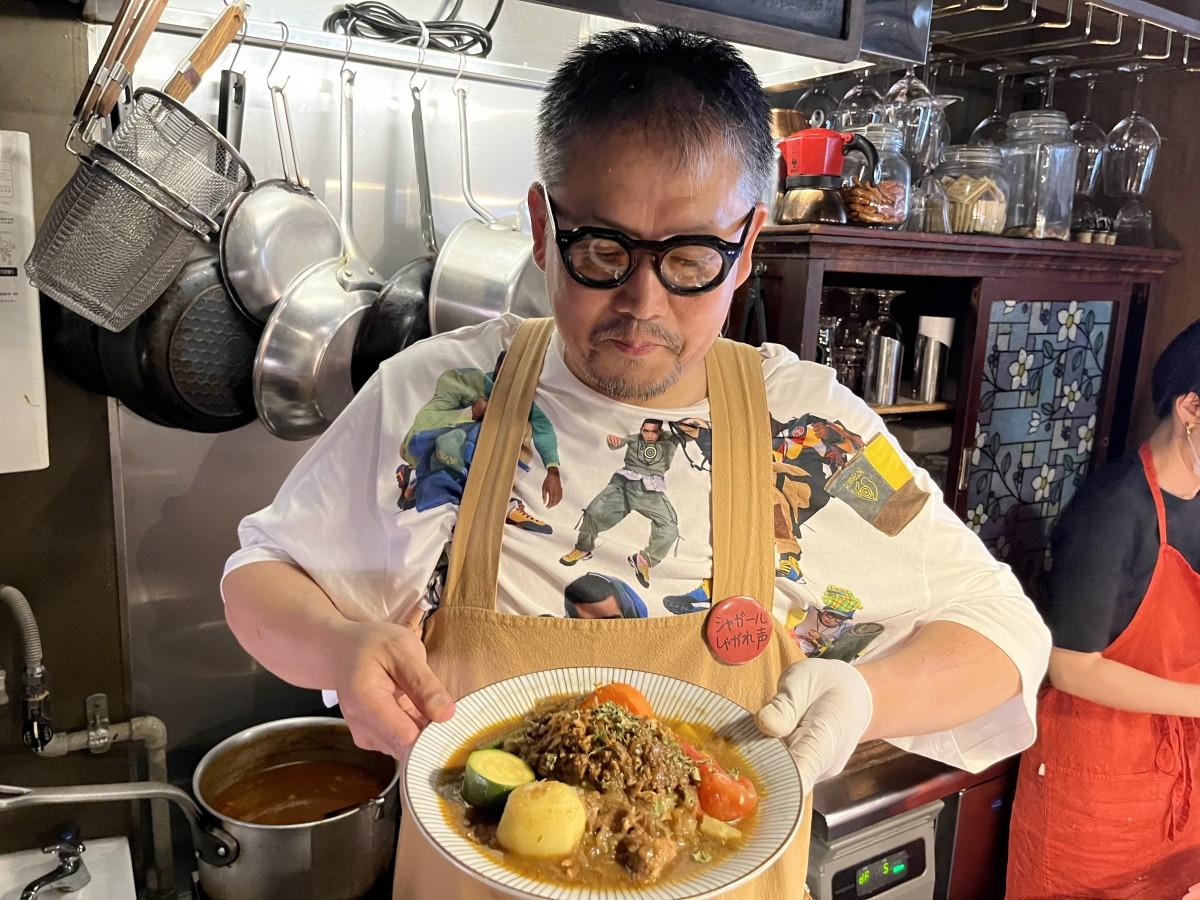 手製のスパイスカレーを手にする店主のかわのさん
