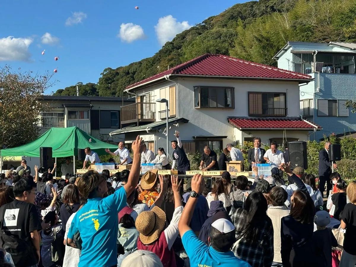 ステージから餅やお菓子がまかれ大勢の来場者で沸く「餅まき」