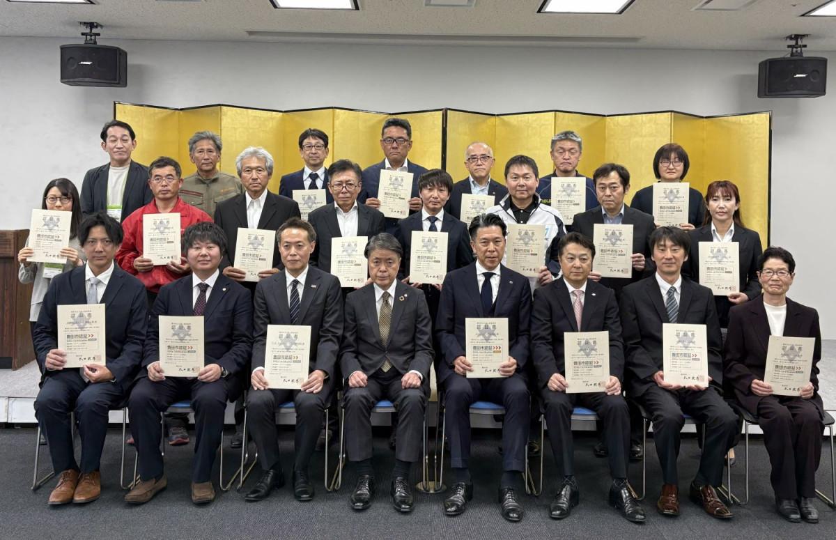太田稔彦・豊田市長（写真中央）と記念撮影に臨む認証書が授与された事業所代表ら。スカイホール豊田にて。