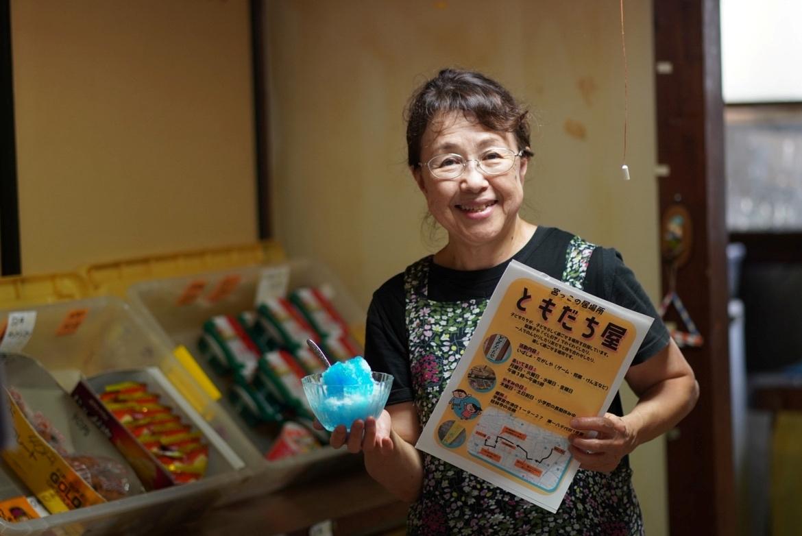 子どもにかき氷を配るボランティアスタッフの小松さん